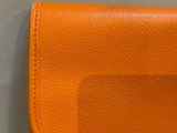 an orange leather wallet with a card holder attached to it