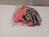 a bag of pink and black items on a white table