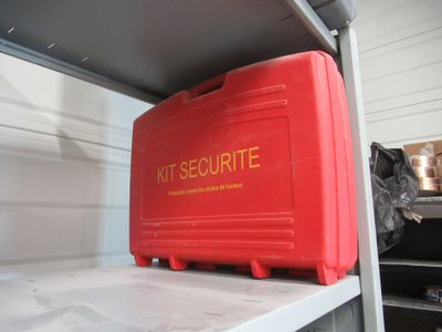 a red box sitting on top of a shelf in a garage