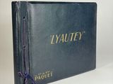 a blue book with a purple string tied to it