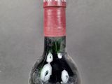 a bottle of wine with a picture of a couple of cats inside of it