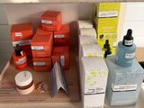 bottles of skin care products sit on a shelf in a bathroom