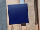 a blue box on a wooden pallet next to a wall