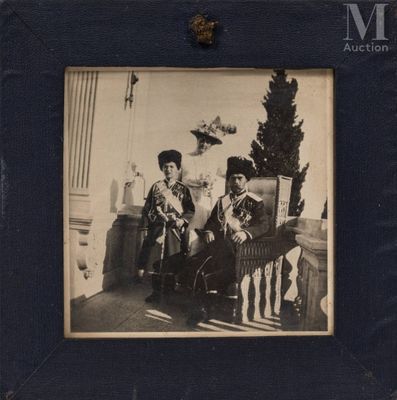 an old photo of two people sitting on a bench