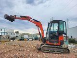 a small excavator that is sitting in the dirt
