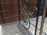 a close up of a wrought iron gate with a glass floor