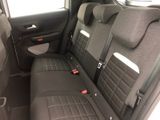 the back seats of a car are black and grey in color