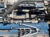 a blue pallet with a bunch of metal pipes on top of it