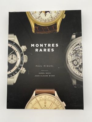 un livre sur lequel sont posées plusieurs montres, posé sur une table