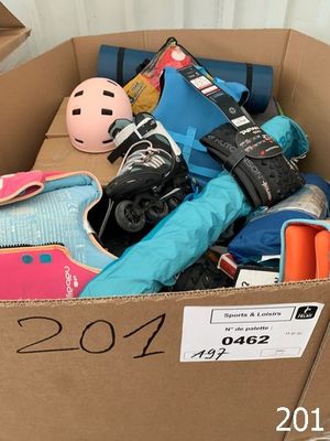 a cardboard box filled with skates and other items
