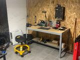 a picture of a garage with a workbench and tools on it