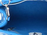 the inside of a blue handbag with a metal handle