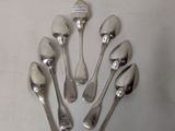 six spoons and two spoon spoons on the table