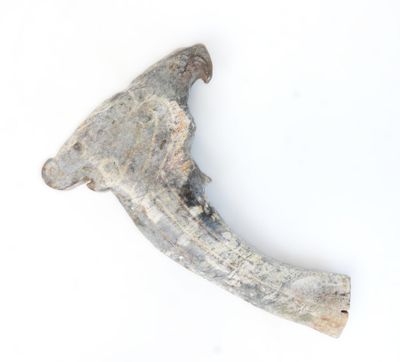 a piece of metal that has been placed on a white surface