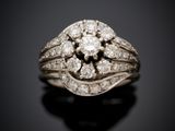 a close up of a diamond ring on a black surface