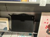 a black purse sitting on top of a shelf in a store