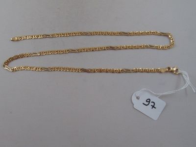 a close up of a gold chain with a price tag on it