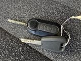 a car key and a remote control on a seat