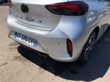 the rear end of a silver car parked in a parking lot