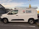 white van parked in a parking lot with a flag on top of it