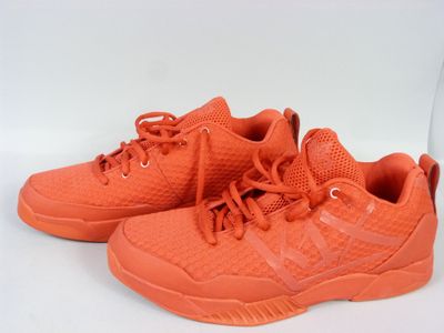 a close up of a pair of orange sneakers on a white background