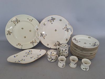 a lot of plates and cups that are sitting on a table