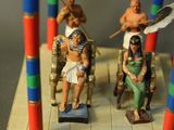 toy figurines of people sitting on a bench in front of a table