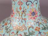 a blue vase with a gold rim sitting on a table
