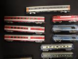 several toy trains are lined up in a row on a black surface