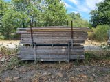 a pile of wood sitting in the middle of a field