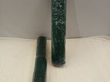 two rolls of green plastic wrap on a table