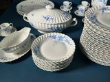 many pieces of blue and white china on a table