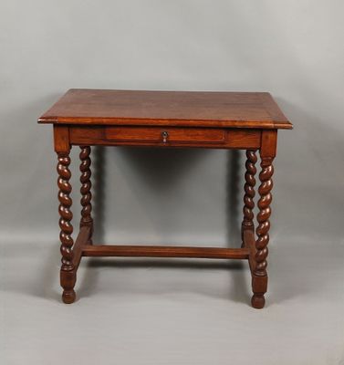 an old wooden table with a drawer on top of it