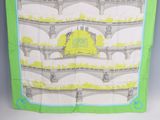 a green and white scarf with a picture of a bridge