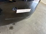 a sticker on the bumper of a car that is parked in a garage