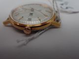 a close up of a watch on a white surface