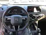 the interior of a car with a steering wheel and dashboard controls