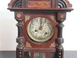 a wooden clock that is sitting on a table
