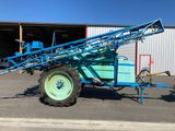 a blue tractor that is parked in front of a building