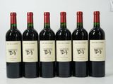 six bottles of red wine are lined up in a row