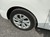 a white car that is parked on the side of the road