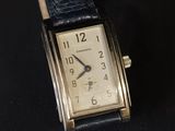 a close up of a wrist watch on a black surface