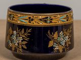 a blue bowl with gold and blue flowers on it