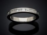 a close up of a diamond ring on a black surface