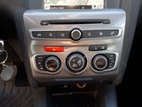 a car dashboard with a car radio and a dash button