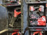 a man holding a tool box full of power tools