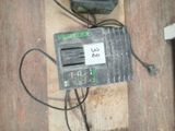 a picture of a cell phone and a charger on a wooden table