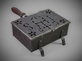a small metal box with a wooden handle on it