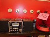 a radio and other electronics on a shelf in a room