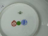 a white plate with a blue and green design on it